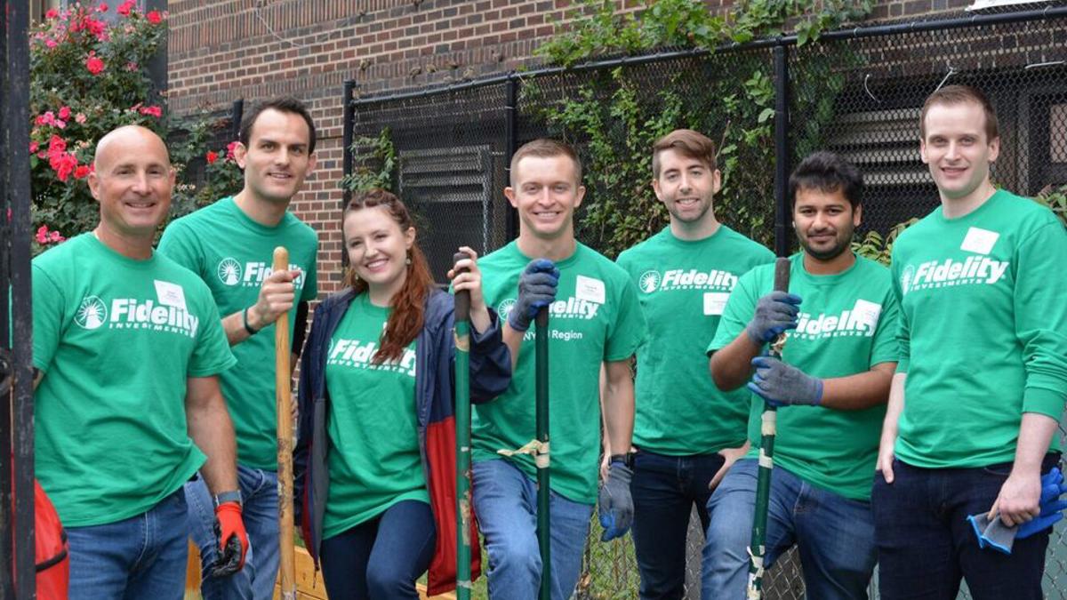 a group of people in green t-shirts