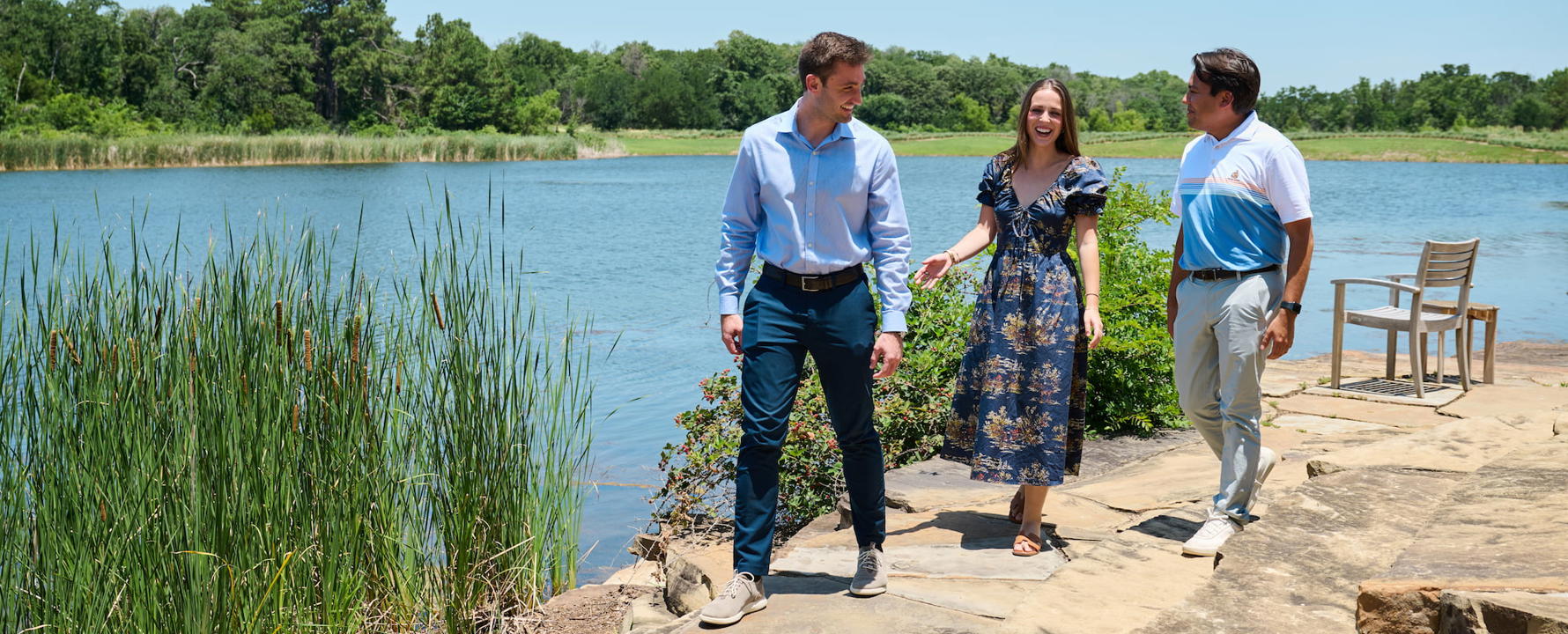 a group of people walking by a lake