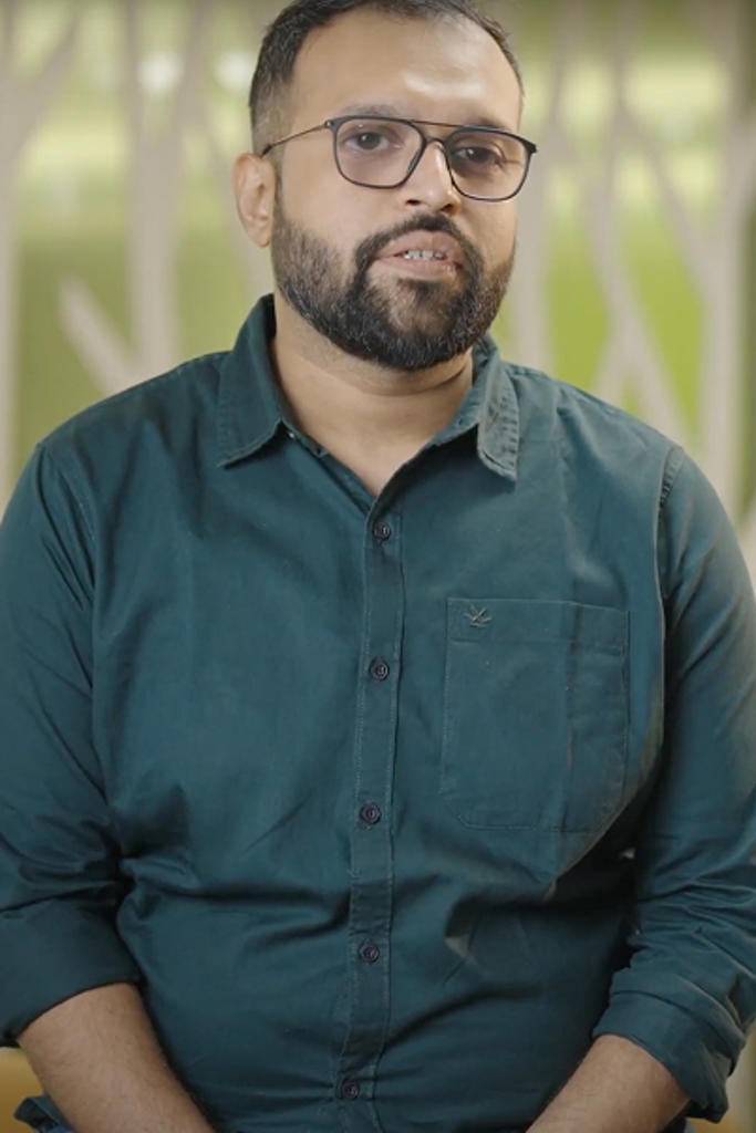 a person wearing glasses and a green shirt