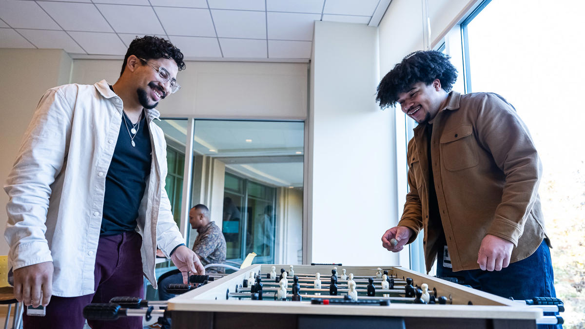 two men playing a foosball