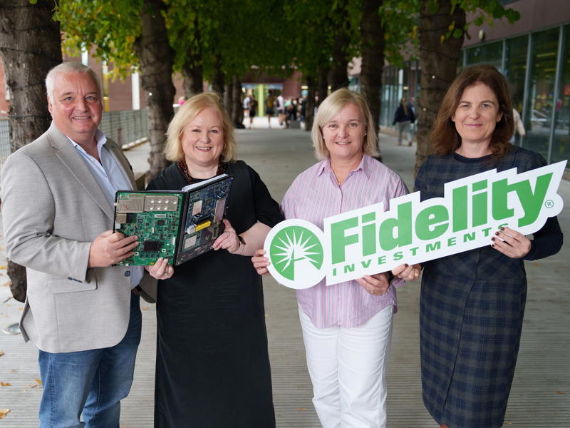a group of people holding a sign and a sign